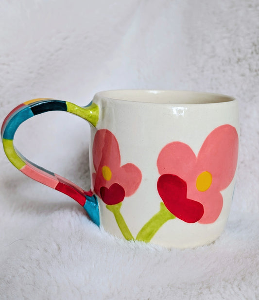 Mug with colorful flower designs on a white background