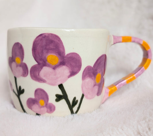 Mug with purple floral design on a white background