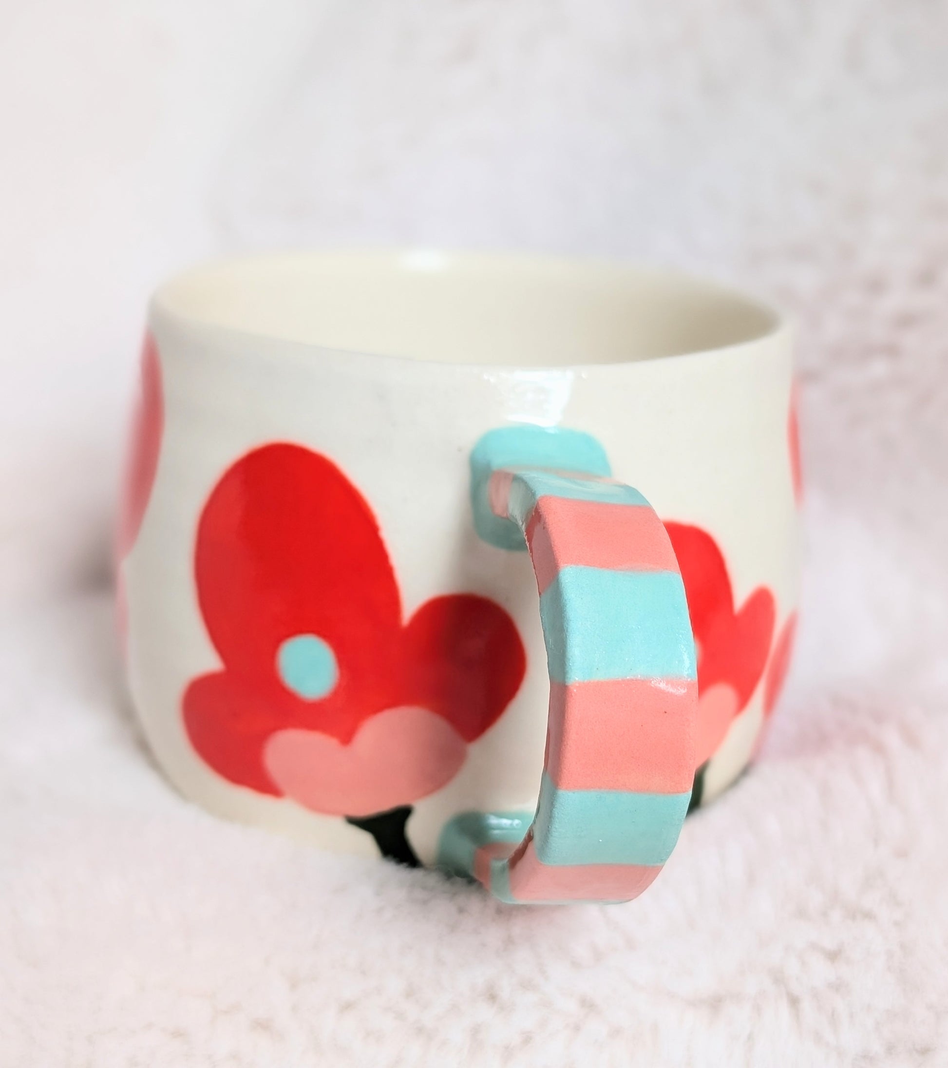 Ceramic mug with coral floral design on a white background