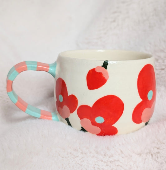 Mug with red coral floral design on a white background